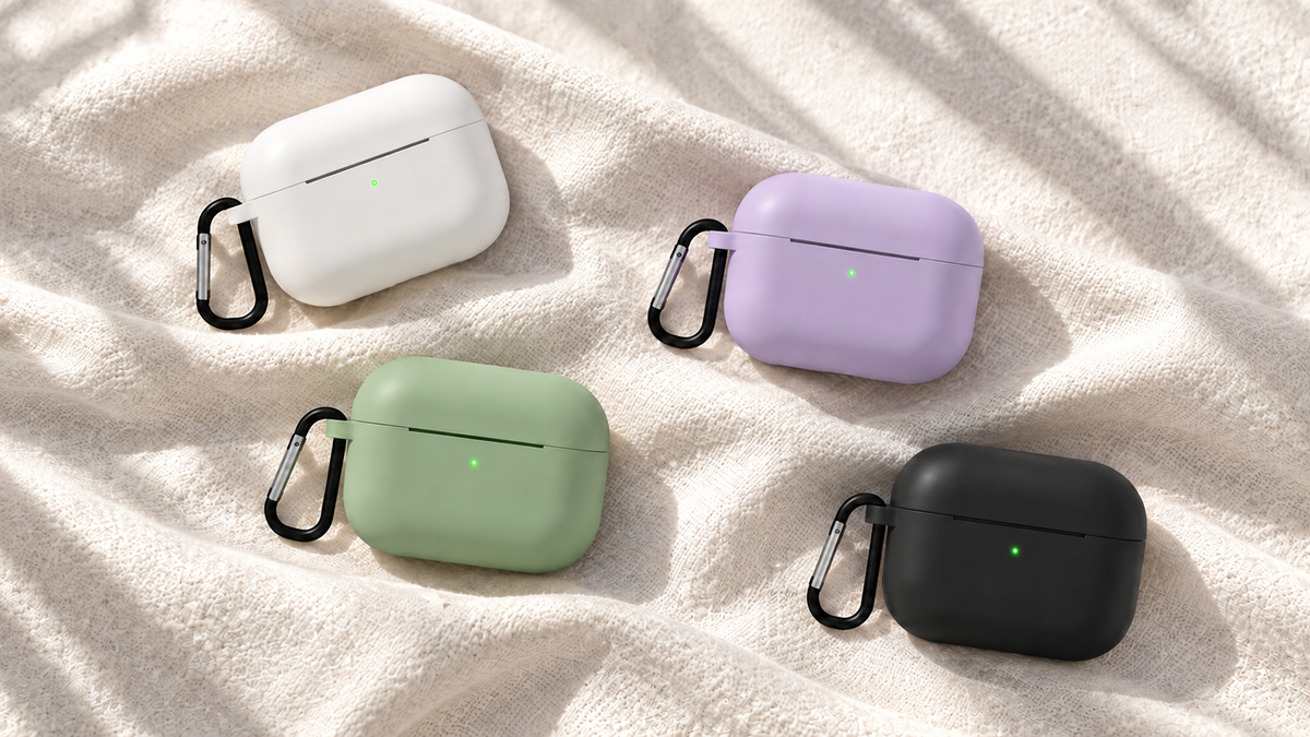 Matcha green, black, white and lavender cases arranged on ivory fabric