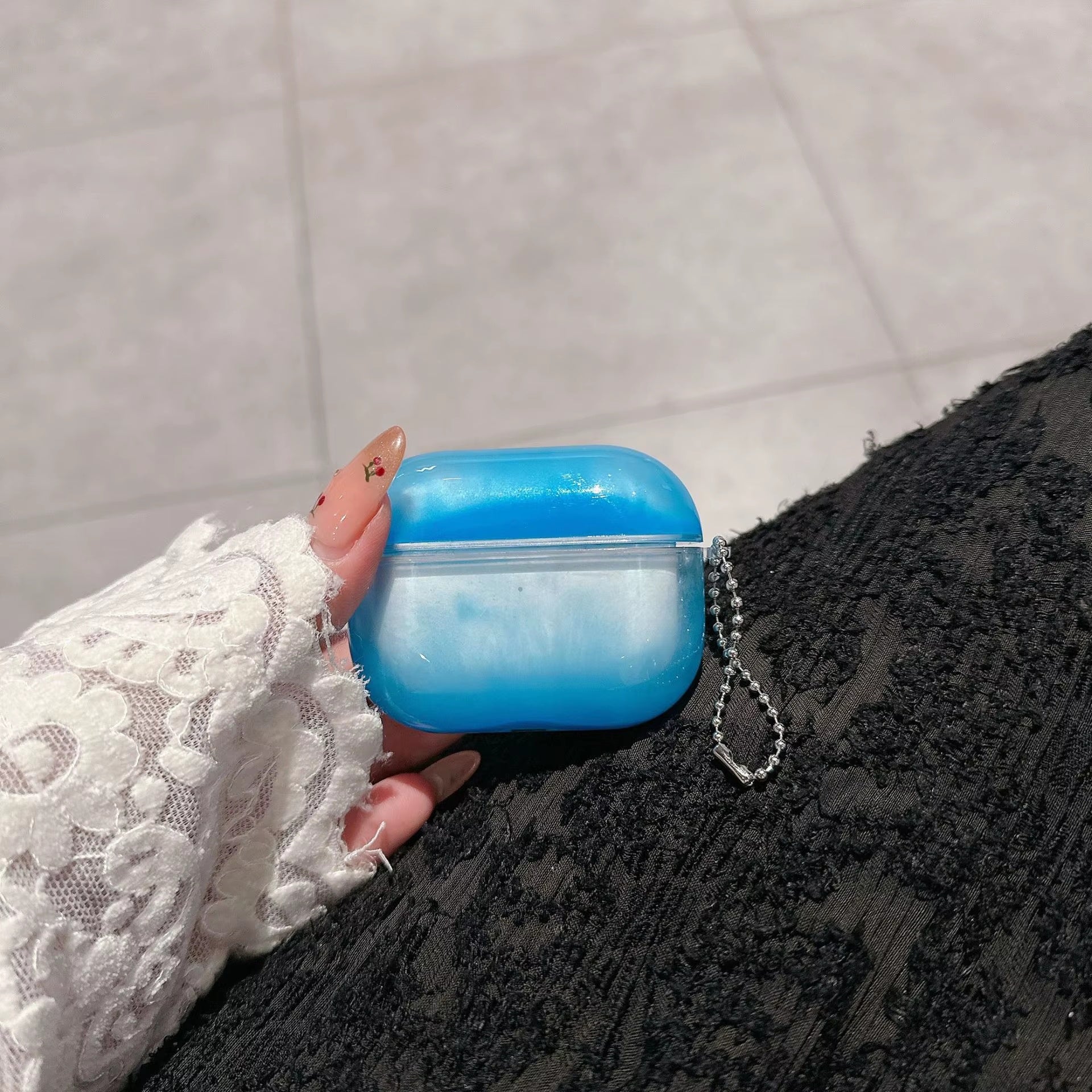Blue Cloud case held beside a black bag